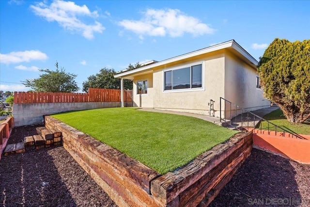 rear view of house featuring a lawn