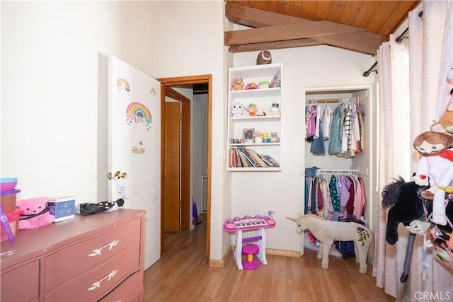 bedroom featuring wood ceiling, a closet, light hardwood / wood-style floors, and vaulted ceiling