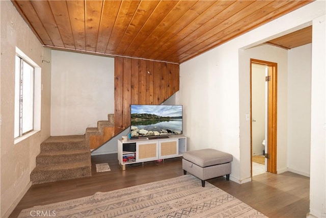 interior space featuring wooden walls, hardwood / wood-style flooring, and wooden ceiling