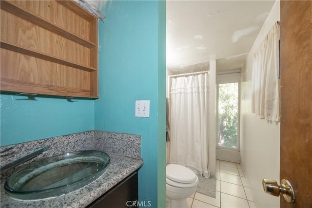 bathroom with toilet, a shower with curtain, vanity, and tile patterned floors