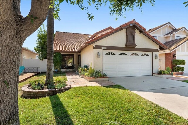 view of front of house with a garage and a front lawn