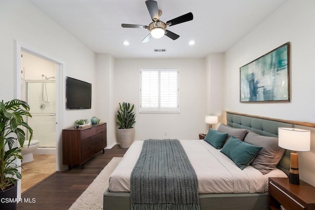 bedroom with ceiling fan, dark hardwood / wood-style flooring, and ensuite bath