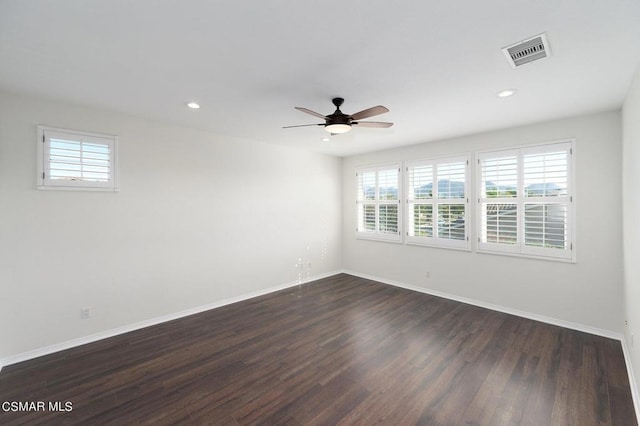 empty room featuring ceiling fan and dark hardwood / wood-style flooring