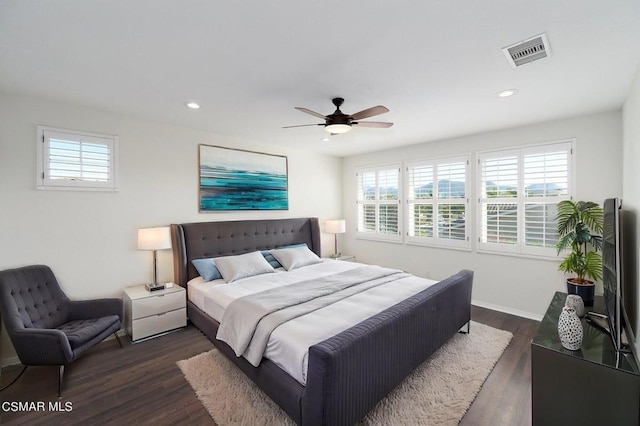 bedroom with ceiling fan and dark hardwood / wood-style flooring