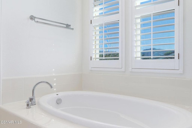 bathroom with tiled tub