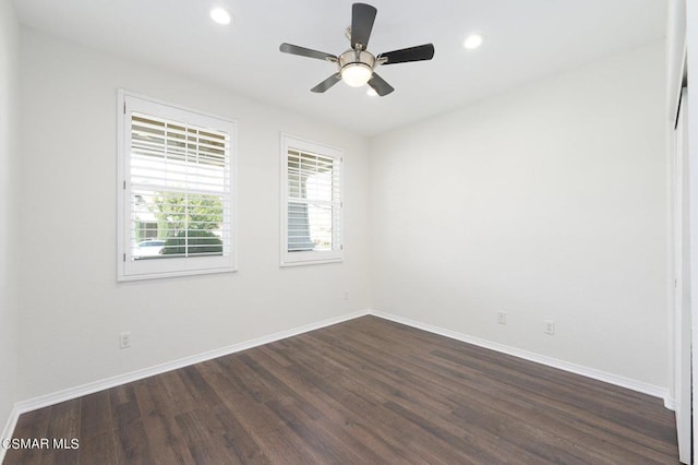 unfurnished room featuring ceiling fan and dark wood-type flooring