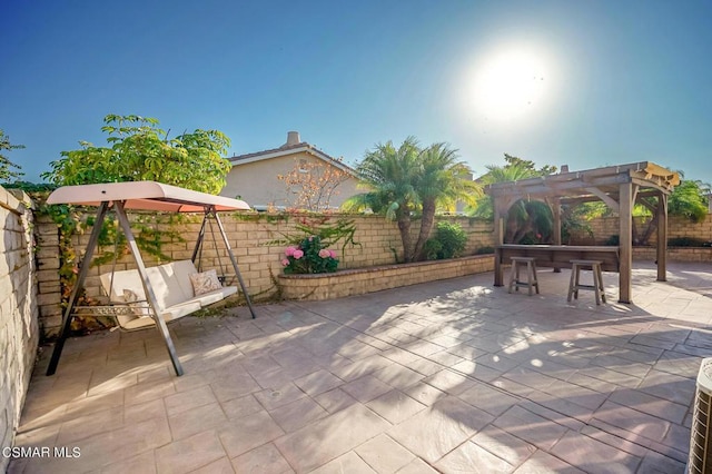 view of patio with exterior bar and a pergola