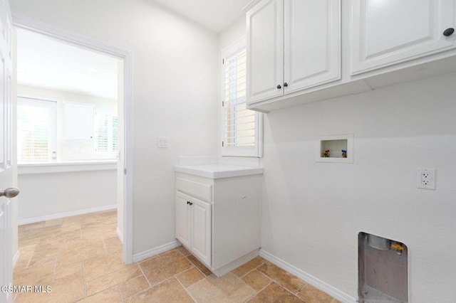 washroom with cabinets and hookup for a washing machine