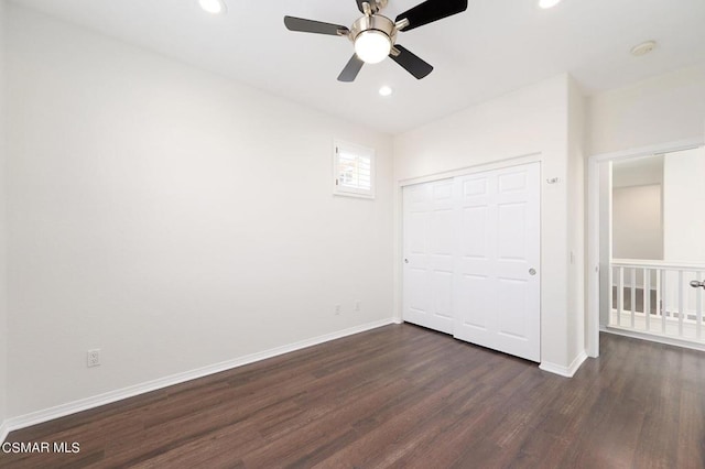 unfurnished bedroom with a closet, dark hardwood / wood-style flooring, and ceiling fan