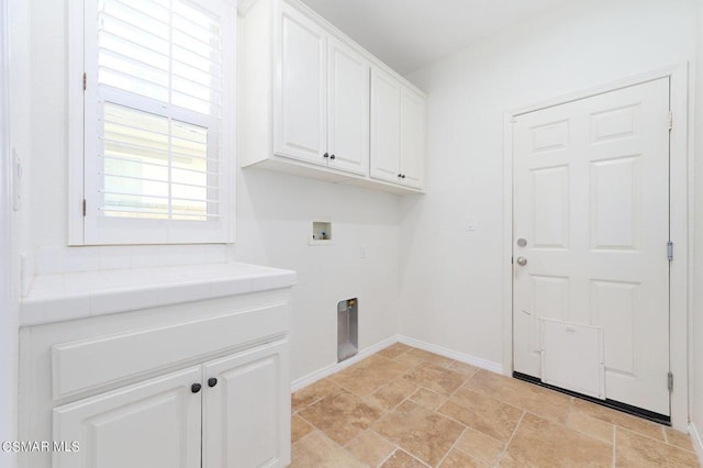 laundry area with washer hookup and cabinets