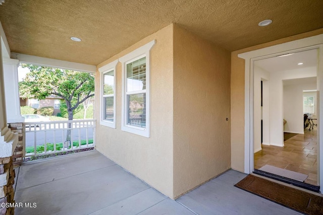 view of exterior entry with covered porch