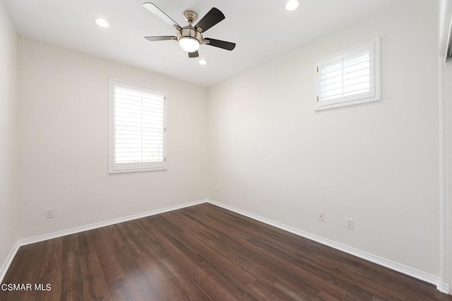 unfurnished room with ceiling fan and dark hardwood / wood-style flooring