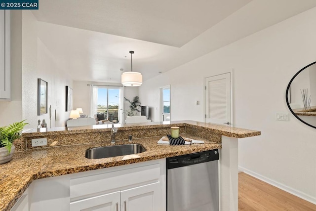 kitchen with white cabinetry, dishwasher, stone counters, pendant lighting, and sink