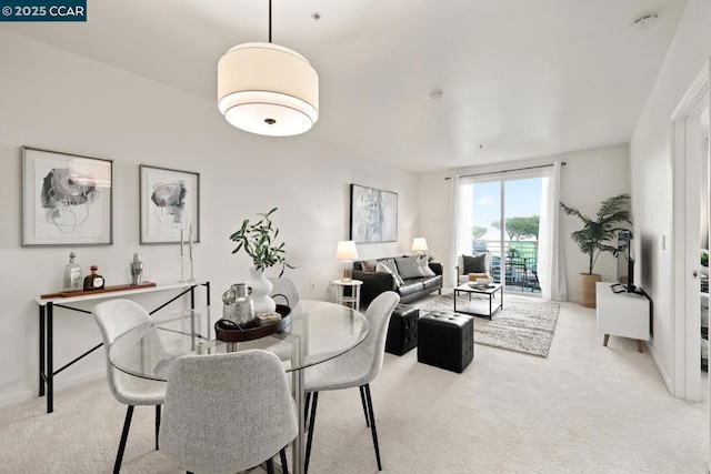 dining area with light colored carpet