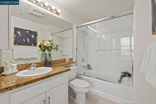 full bathroom featuring toilet, vanity, shower / bath combination with glass door, and tile patterned flooring