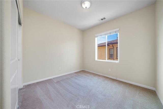 unfurnished room with light carpet