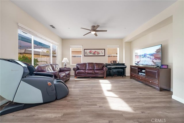 living room with ceiling fan and light hardwood / wood-style flooring