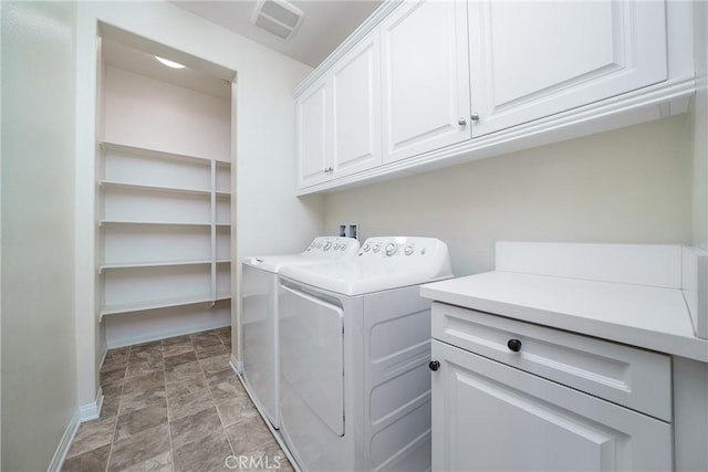 laundry room featuring cabinets and washing machine and clothes dryer