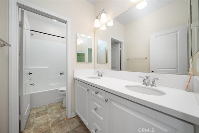 full bathroom featuring toilet, vanity, and  shower combination