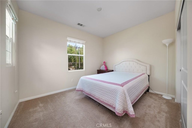 bedroom featuring light colored carpet