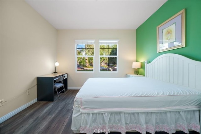 bedroom with dark hardwood / wood-style flooring