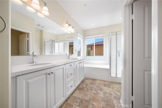 bathroom with vanity and plus walk in shower