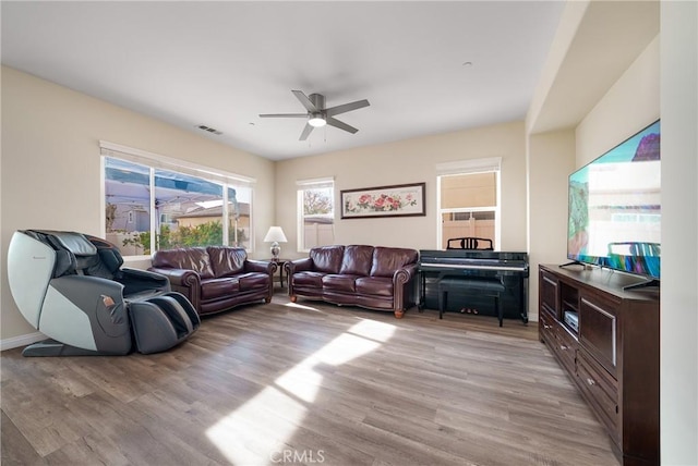 living room with ceiling fan and light hardwood / wood-style floors