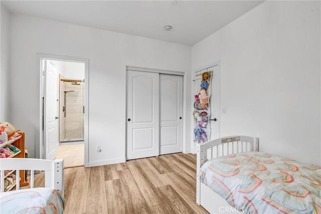 bedroom with light wood-type flooring and a closet