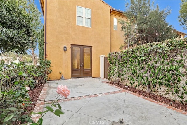 rear view of property featuring french doors and a patio