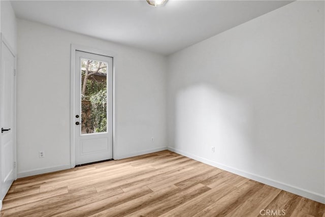 empty room with light hardwood / wood-style flooring