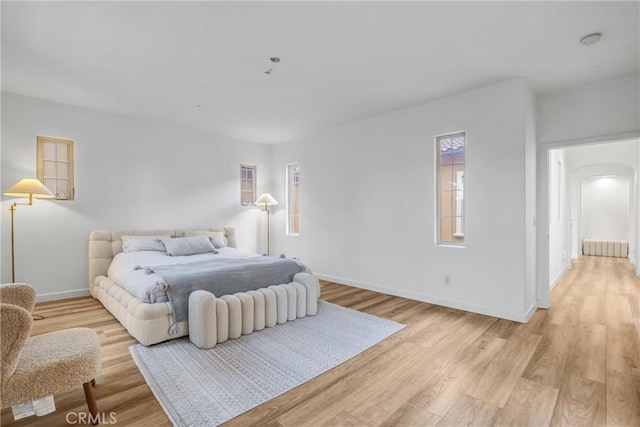 bedroom with radiator and light hardwood / wood-style floors