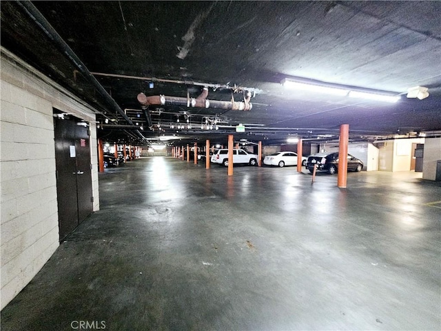 parking garage featuring concrete block wall