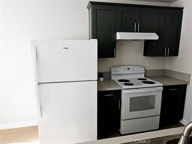 kitchen featuring light wood-type flooring and white appliances