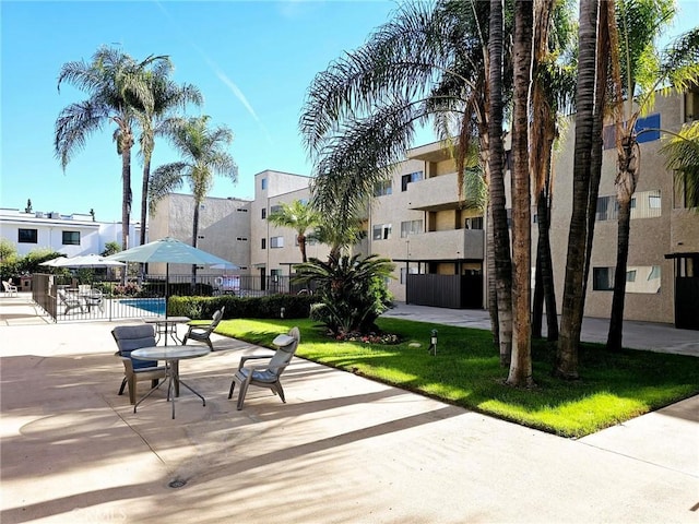 view of community with a patio area and fence