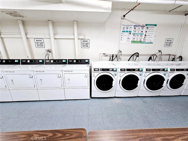 shared laundry area with washer and clothes dryer, visible vents, and tile patterned floors