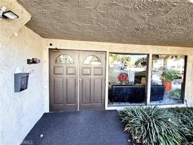 property entrance featuring stucco siding