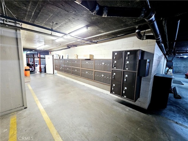 exterior space featuring concrete block wall and mail area