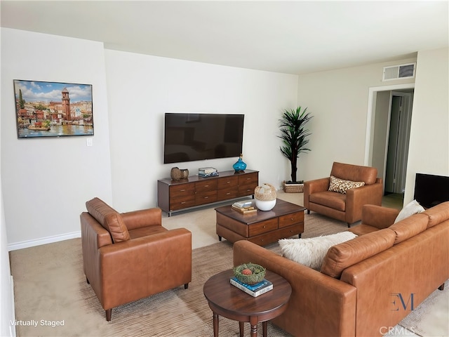 living area featuring carpet, visible vents, and baseboards