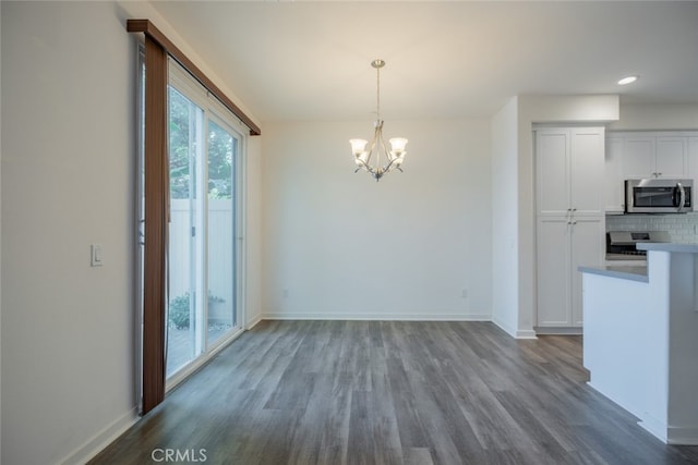 unfurnished dining area with light wood-type flooring and an inviting chandelier