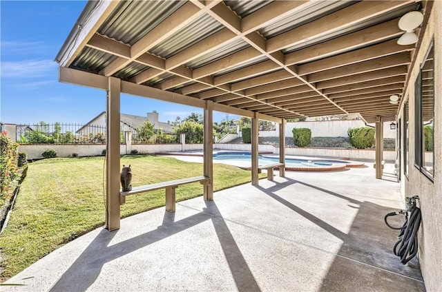 view of patio / terrace with a swimming pool with hot tub