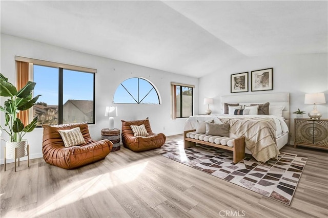 bedroom featuring hardwood / wood-style flooring and lofted ceiling