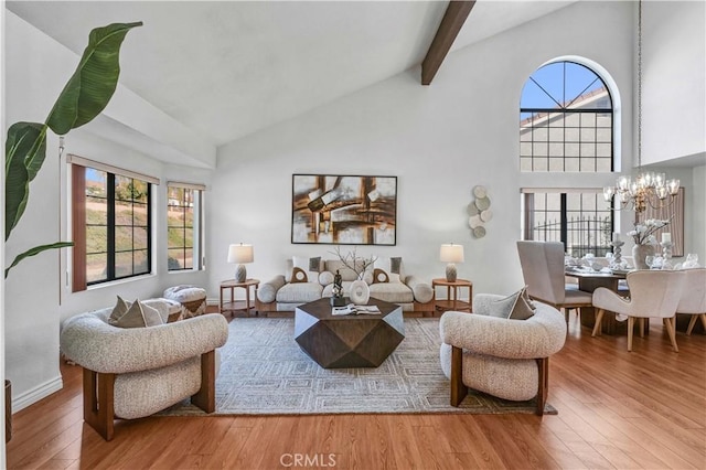 living room with hardwood / wood-style flooring, plenty of natural light, and a notable chandelier