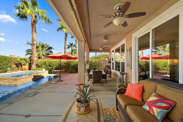 view of patio / terrace with ceiling fan, an outdoor living space, and an in ground hot tub