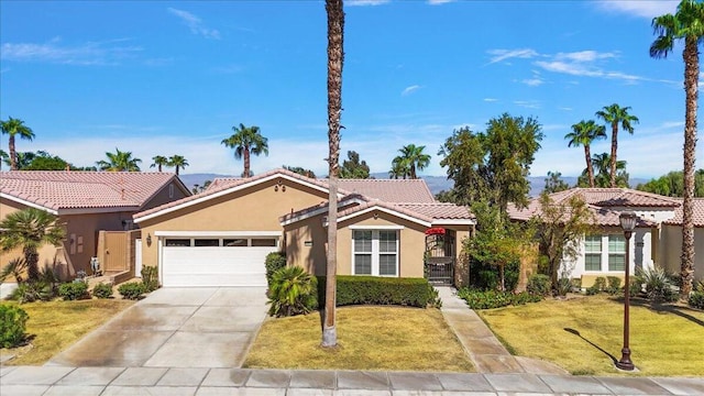 view of front of property featuring a front lawn and a garage