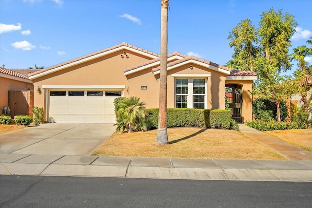 mediterranean / spanish-style home with a garage