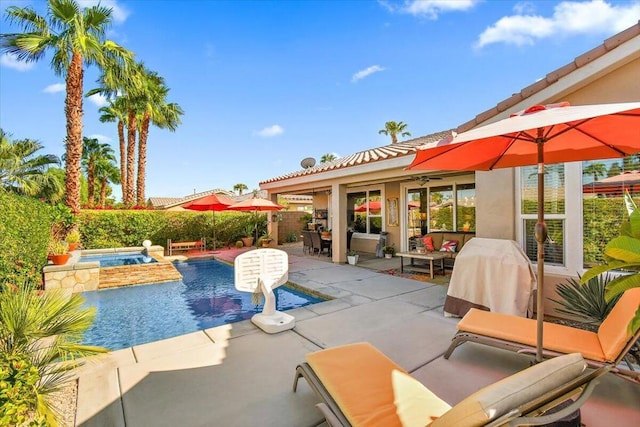 view of pool with an outdoor hangout area, a patio, and an in ground hot tub