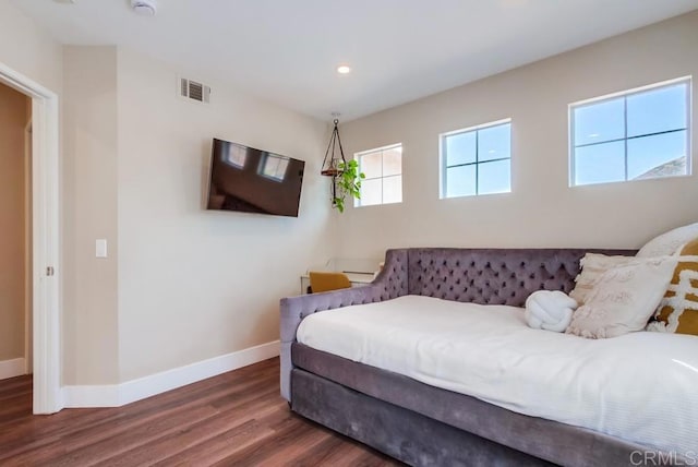 bedroom with dark hardwood / wood-style flooring