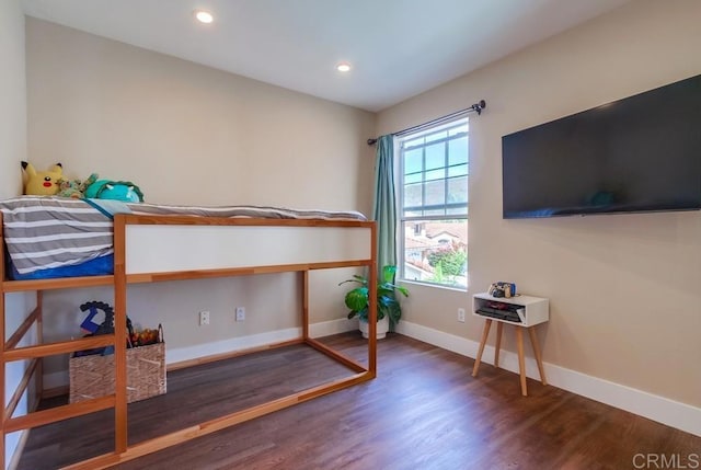 bedroom with dark wood-type flooring