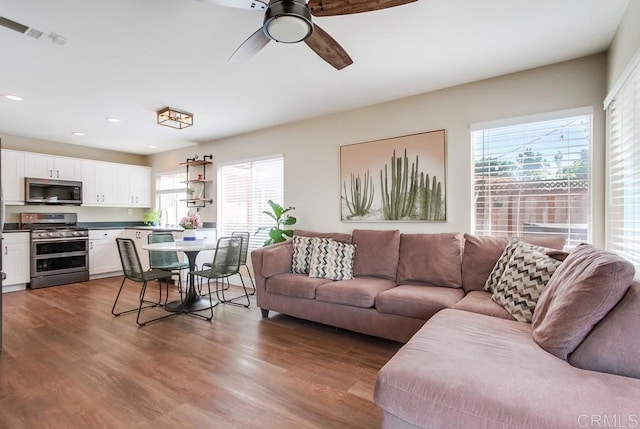 living room with ceiling fan, hardwood / wood-style floors, and sink