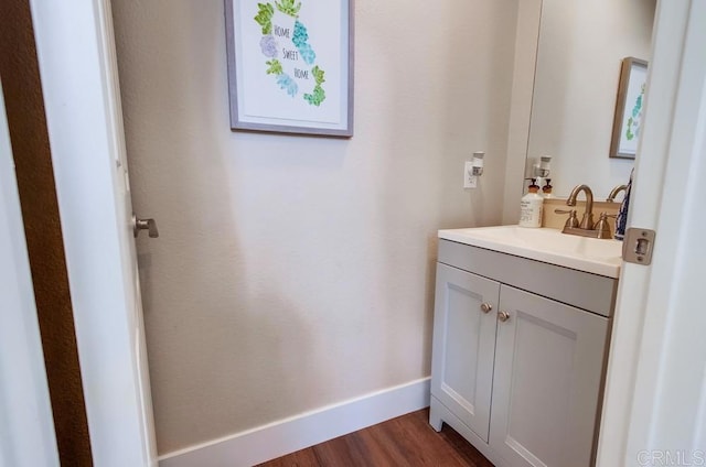 bathroom with hardwood / wood-style flooring and vanity